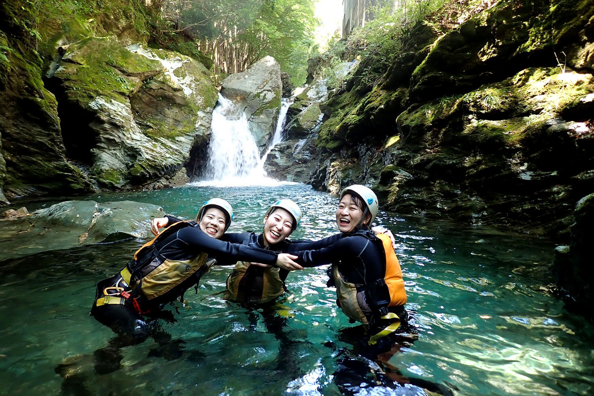 Canyoning beneath a waterfall in the Hamamatsu region.