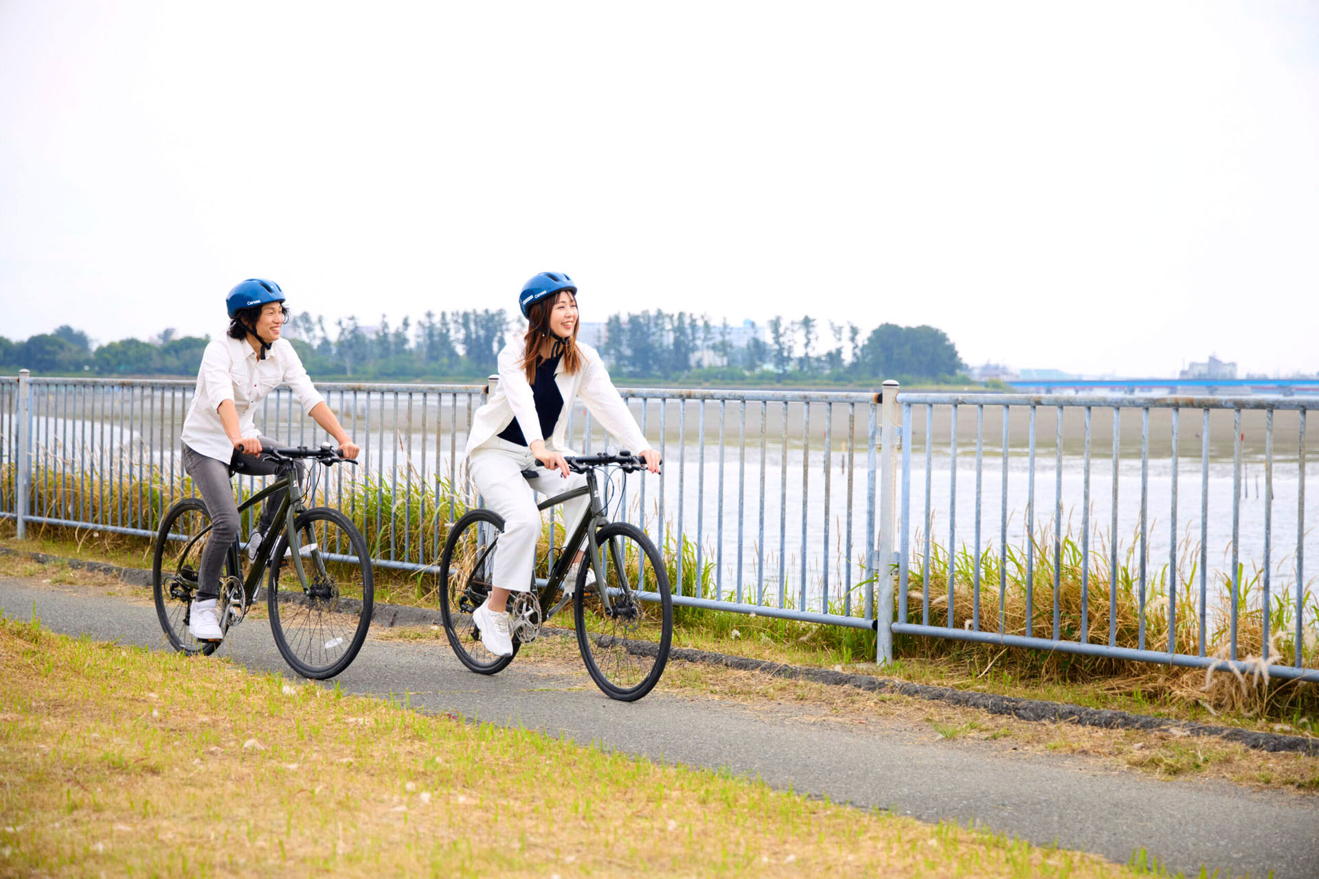 Cyclists riding beside Lake Hamana in Hamamatsu, Japan.