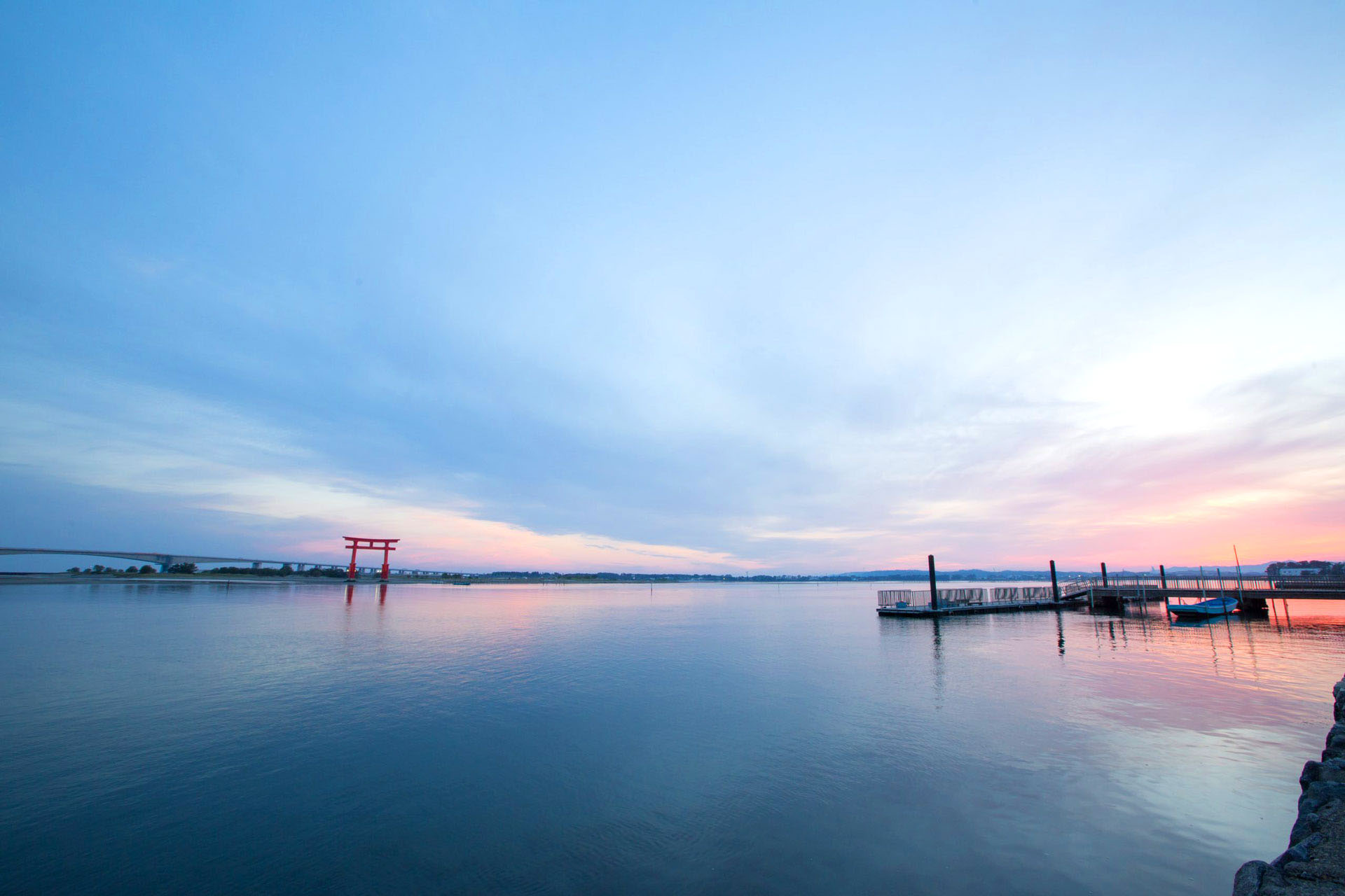 Red torii gate in Lake Hamana at sunset in Hamamatsu.