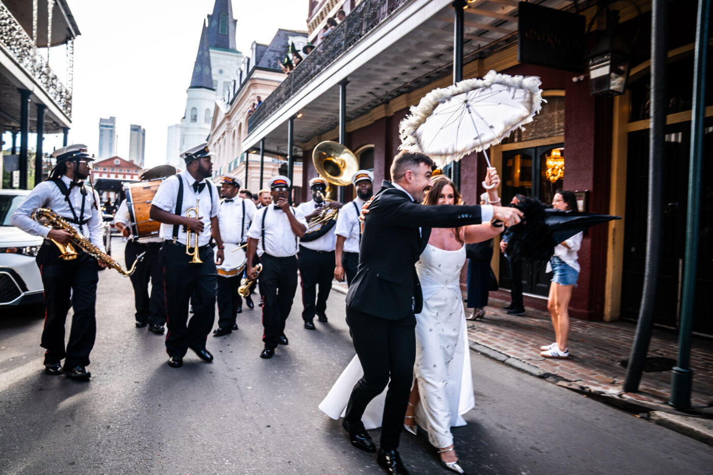 A bridal party parading down the street.