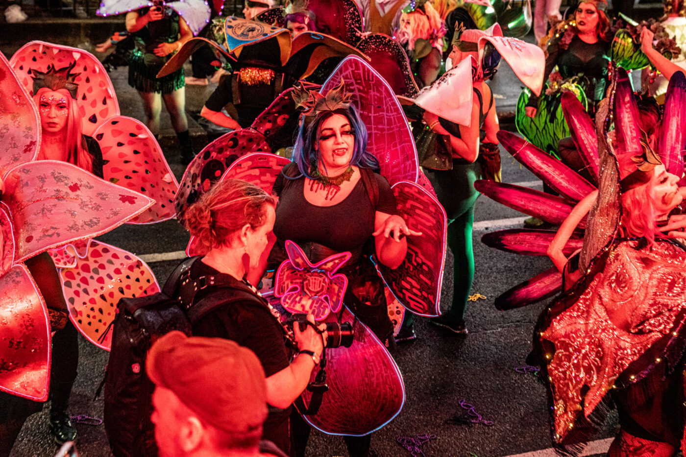 A group of people with pink wings and scary makeup.