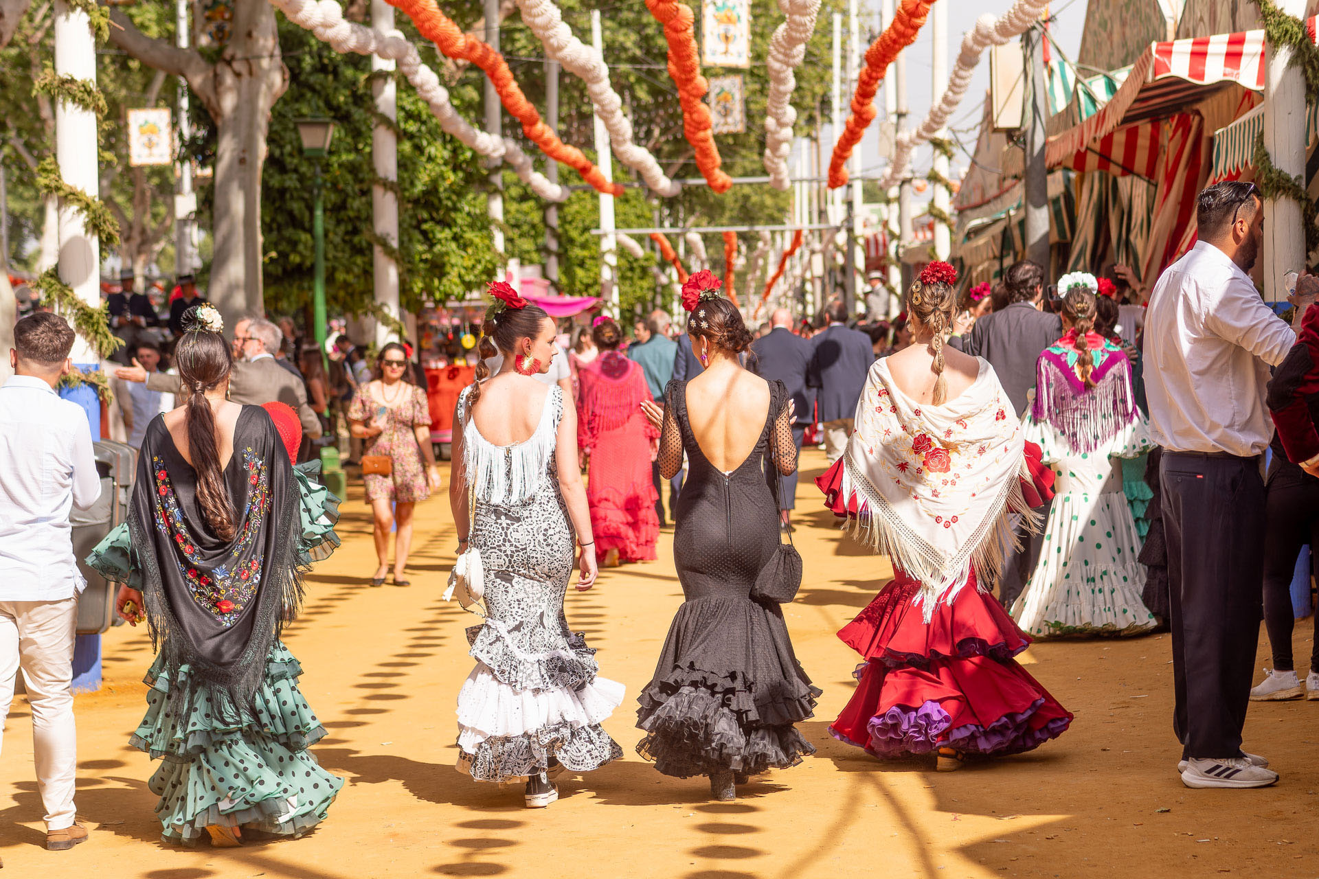 Women in flamenco dresses at a festival in Seville, Spain.