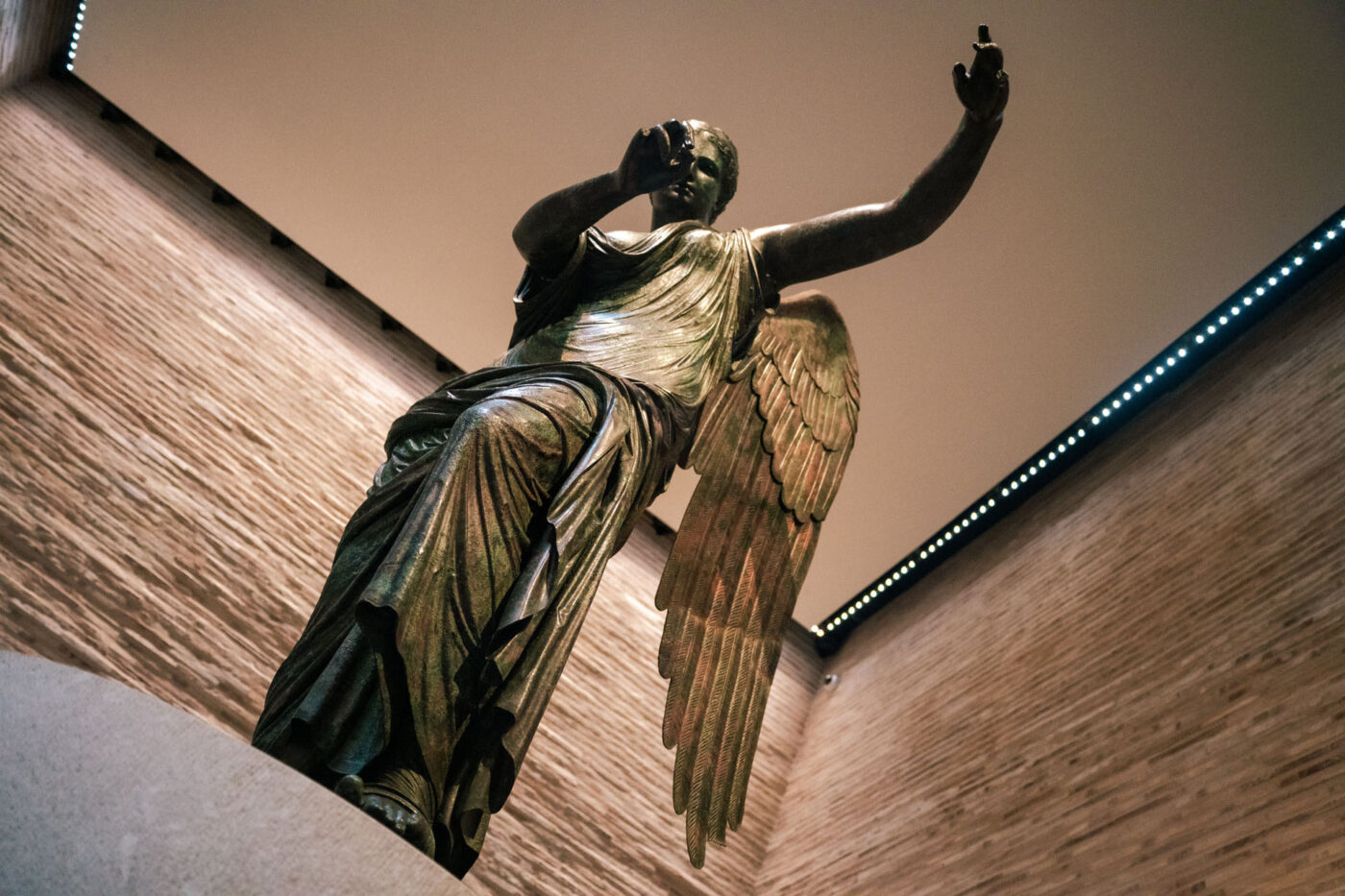 A statue of an angel with it's hands held out.